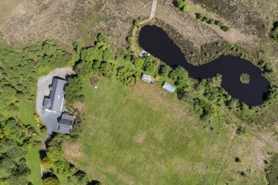 Looking down on Mucmara Lodge, its garden and beautiful private loch in the grounds