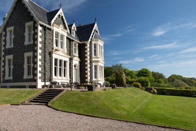 Arriving at Oakfield House, with a manicured lawn and sea views
