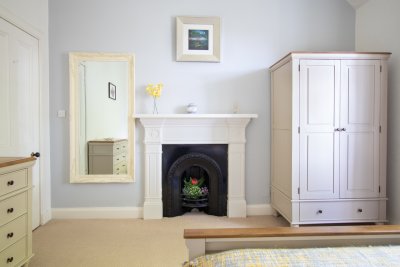 Ample storage in the twin bedroom and feature fireplace