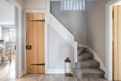 The staircase leads up around a corner to the cottage's sleeping quarters upstairs