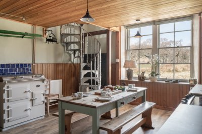 The kitchen retains a rustic vibe, yet offers self-catering with ease