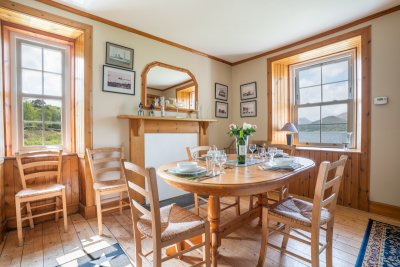 Old School House dining room with double aspect windows, letting in lots of natural light