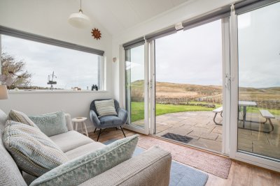 The sun room offers a second relaxing living space at Ploughman's Cottage, the perfect spot to curl up with a page-turner or perhaps put pen to paper