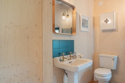 The boot cupboard and entrance to the bathroom with pocket door