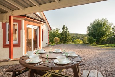 Covered alfresco dining with lovely woodland and glen views