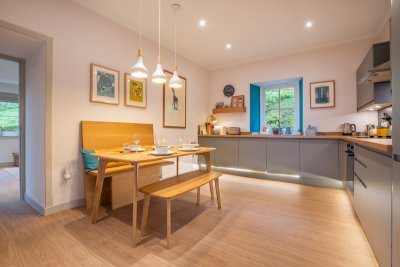 Feature lighting frames the dining area in the kitchen