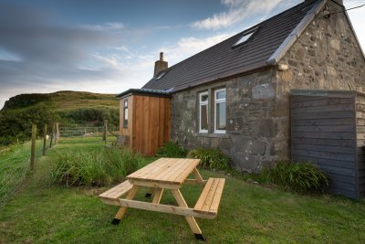 Dine alfresco in the garden overlooking the beach