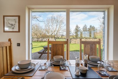 Dining table with lovely views to the rear garden and decking