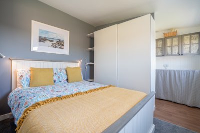 The bedroom area and bathroom space just beyond