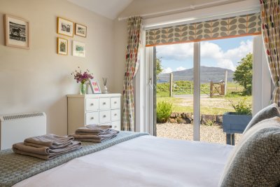 The master bedroom is filled with light thanks to the patio doors bringing the garden in