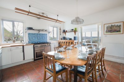 Sunny kitchen with dining table is a great place for families to eat and play games