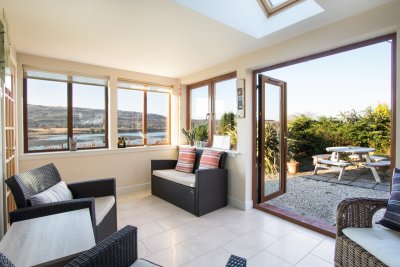 Double doors in conservatory open to the patio