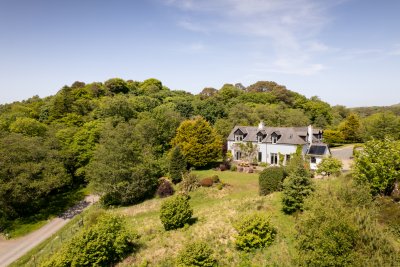 Torrbreac enjoys privacy in mature gardens with pathways to explore overlooking the loch
