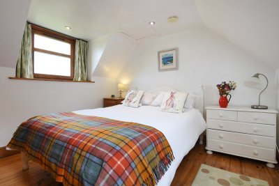 This beautifully furnished double bedroom can be found upstairs