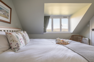 Tucked in the eaves is the charming master bedroom