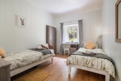 The twin bedroom is elegantly decorated with a rustic, country feel