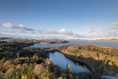 Bird's eye view of the Aros Park lochan and waterfalls meeting the sea in Tobermory Bay