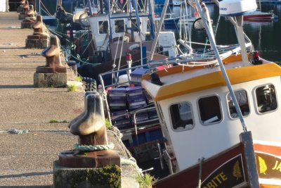 The stone pier and fishing boats