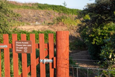 The garden gate with path to the shore below the house