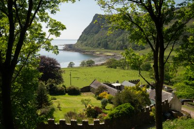 Looking over Carsaig Gardens to the beach and headland beyond