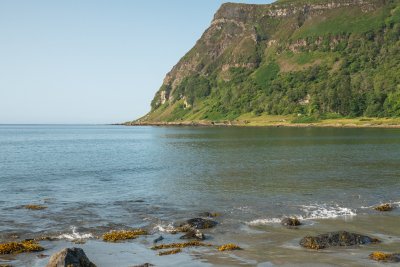 Marvel at the striking black sand at Carsaig Bay