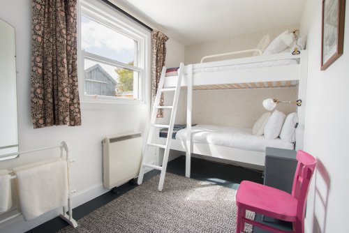 Bunk beds in the bedroom to the rear of the cottage