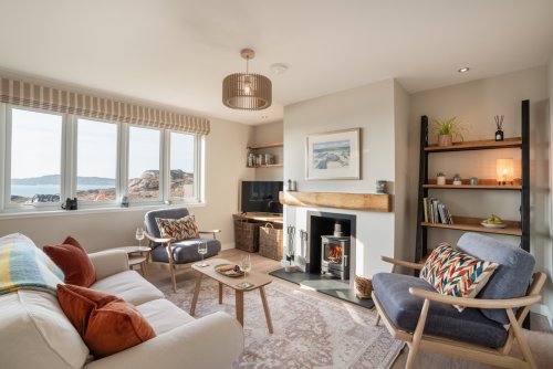 Gather around the wood burner and relax with wonderful views over the sea