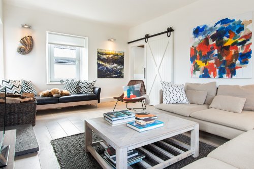 The Art House's light-filled living room, complete with original artwork from which the house takes its name