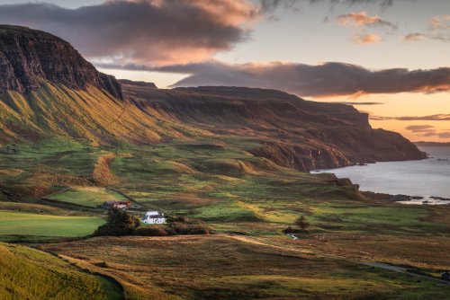 Balmeanach Farmhouse set beneath the cliffs on the dramatic coastline at Gribun