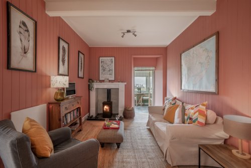 The living room feels oh-so inviting with a warm palette and plenty of comfy furnishings