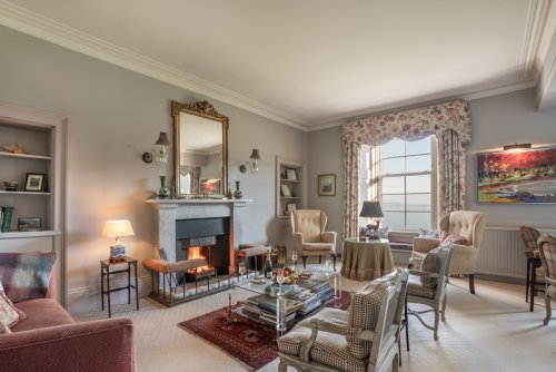 Gather around the roaring fire in the formal reception room with sea views