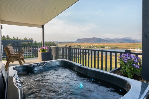 Relax in the hot tub as you watch the tides change at Cherry Tree Lodge