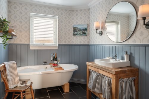 The indulgent ground-floor bathroom blends luxury with a laid-back, farmhouse feel