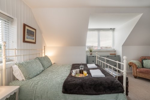 Each bedroom is elegantly appointed, including the master pictured here