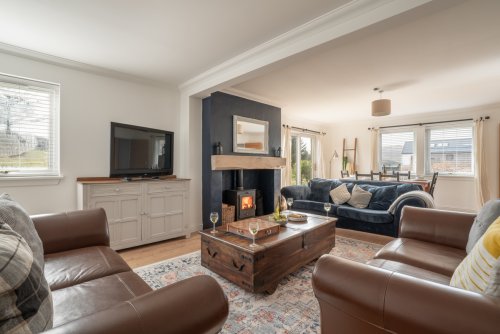 The wood-burning stove lends the living area a warm and welcoming feel