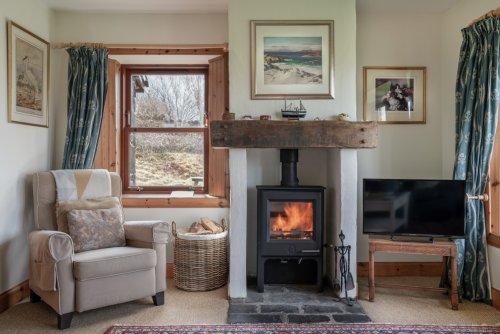 The wood-burning stove adds a lovely feature to the living space