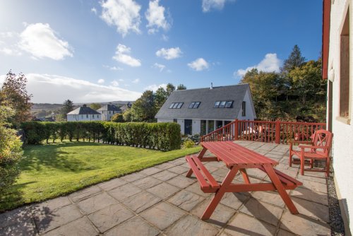 Patio at the front of the house with picnic bench