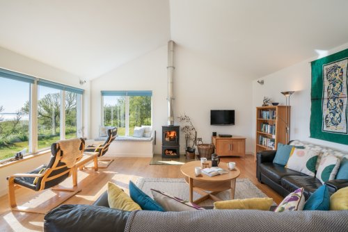 The wood burning stove adds a focal point if you can peel your eyes away from the view