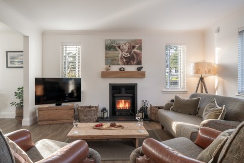 Sink back in front of a cosy fire in the spacious living room