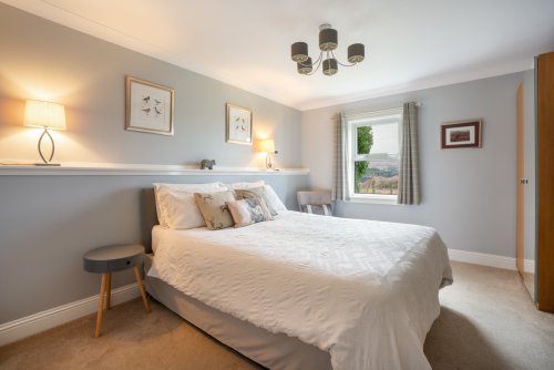 Enjoy a restorative night's sleep in the beautiful master bedroom