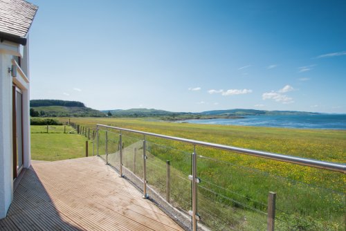 Take in the superb sea views from the decking and garden at Eala Bhan