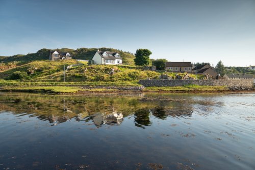 Superb setting of Dragonsfly Rest above the bay on the edge of the village