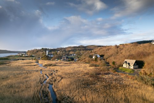 Half Moon House's peaceful setting overlooking the River Bellart, which flows into Loch Cuin beyond