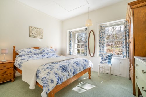 Picturesque windows frame the views and fill the double bedroom with light