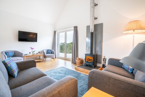 spacious living room with double doors opening to the decking