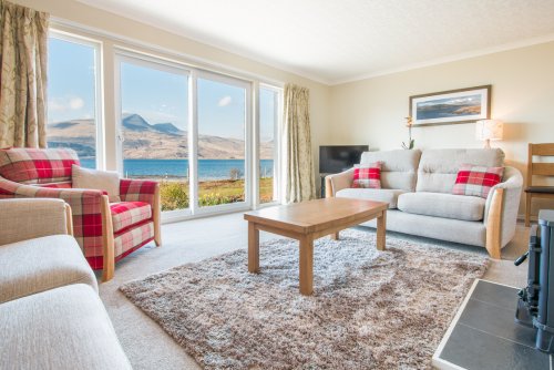 Living area with wood burning stove and sea views