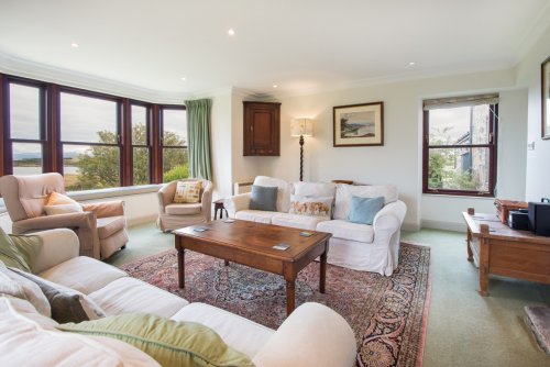 Large living room with huge bay window capturing the views