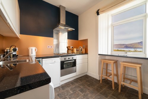 Contemporary kitchen with copper splashback in the Bothy