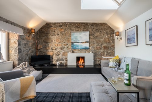 The heart of the home with an open fire, Lorne Cottage feels utterly cosy with its character features and warm ambiance