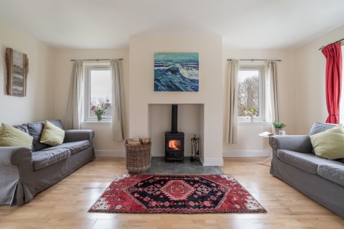 And relax! The living room at Puffin features a centrepiece wood burning stove and lots of natural light.